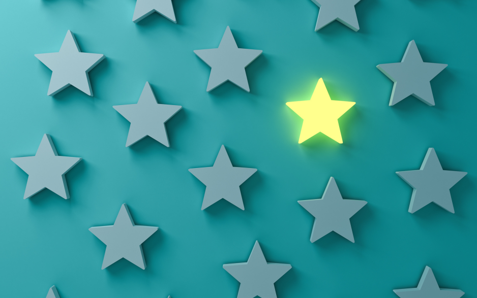 A pattern of gray stars on a turquoise background, with one star glowing yellow to stand out.