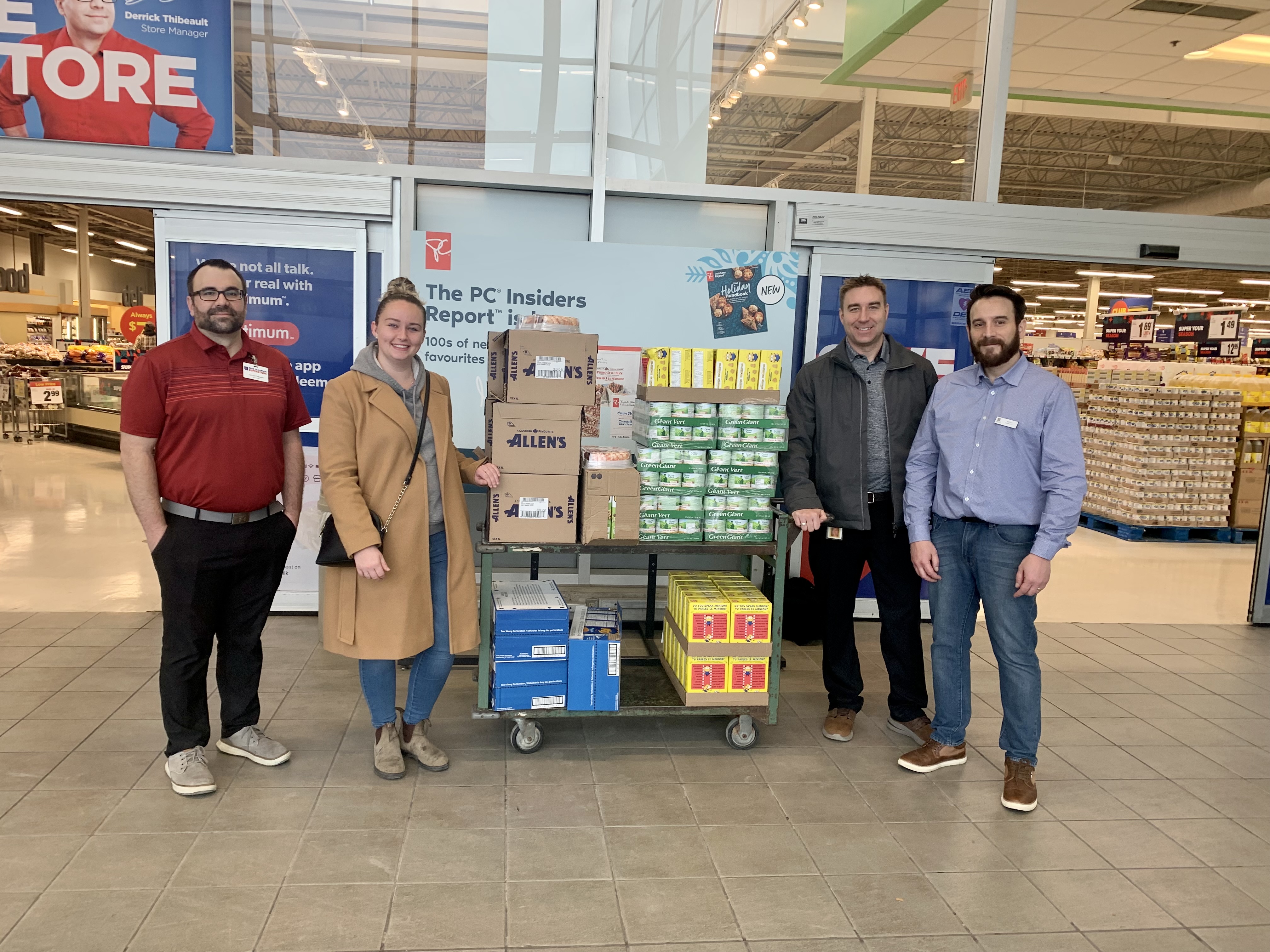 holiday food drive people with a cart of food drive donations