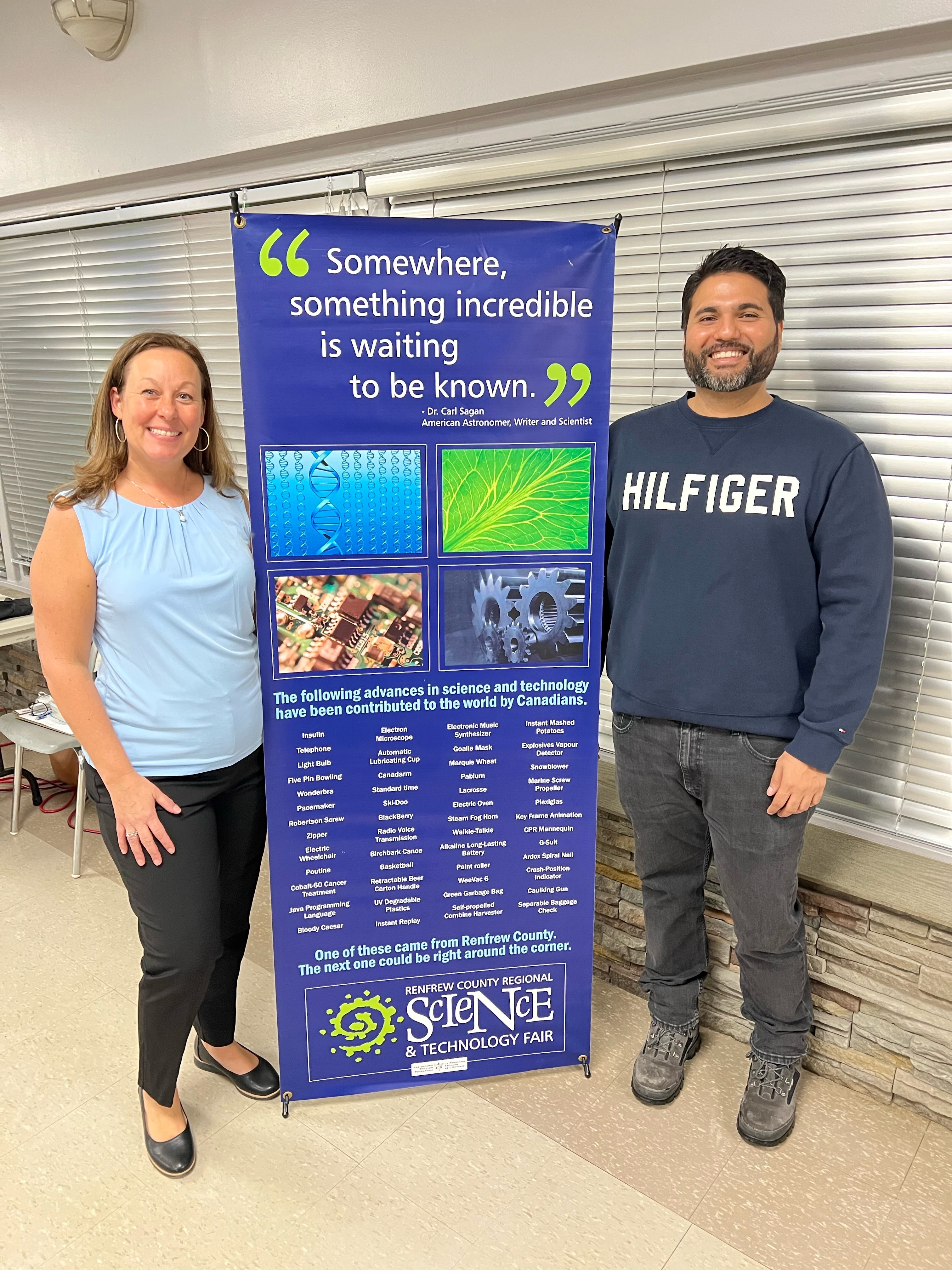 County Science Fair Man and woman in front of Renfrew County Regional Science & Technology Fair Sign